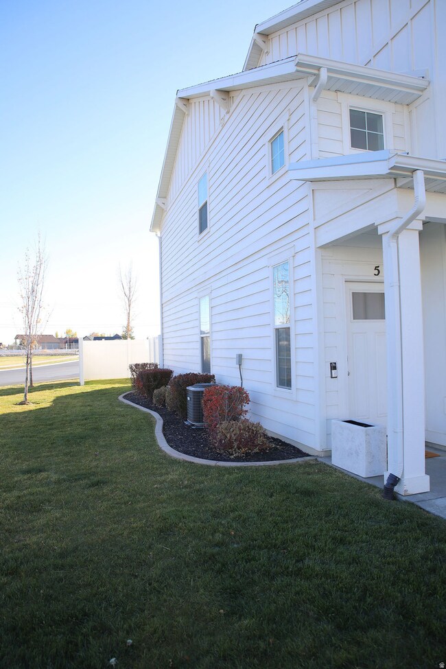 View of side of home featuring board and batten siding and a lawn