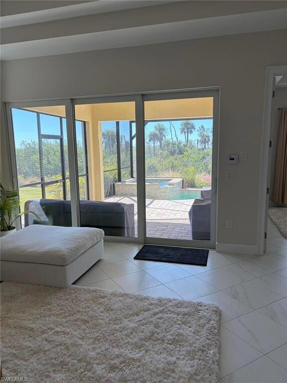 Doorway to outside with baseboards