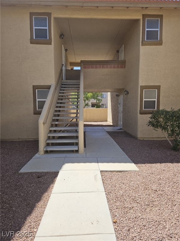 Property entrance featuring stucco siding