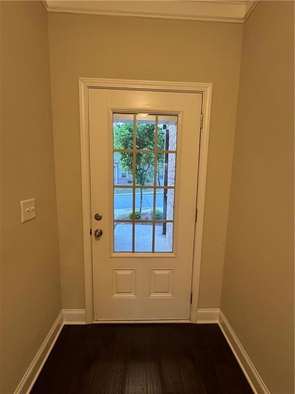 Doorway featuring dark wood-style flooring, crown 