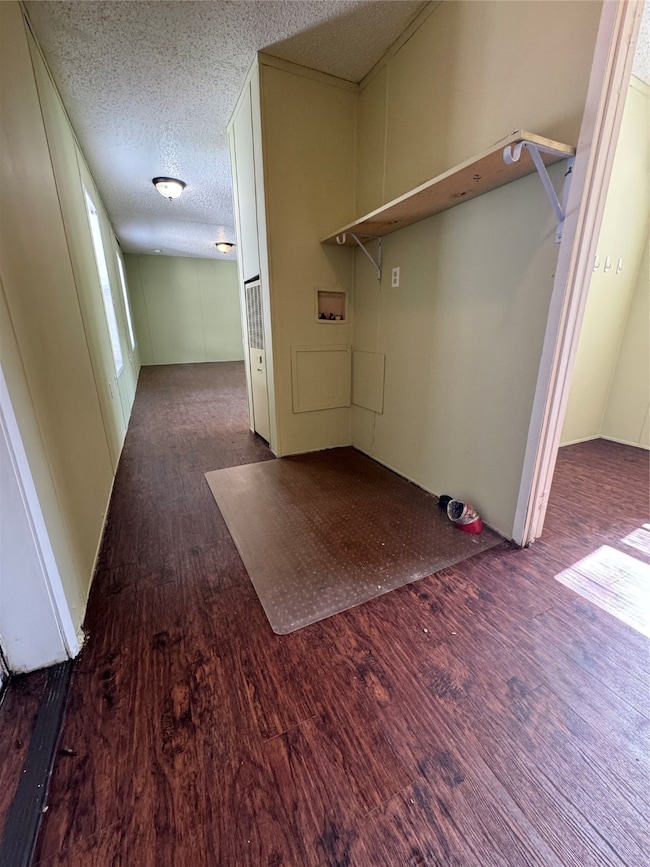 This efficient utility area offers practical space for laundry and storage, conveniently located within the home.