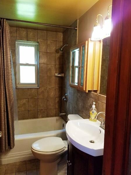 Full bath, updated commode, sink, ceramic tile wal