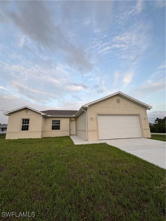 Ranch-style house with stucco siding, an attached