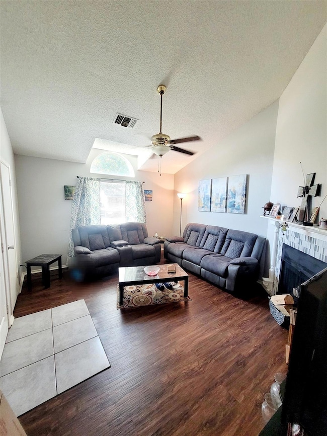 Living room featuring a textured ceiling, vaulted 