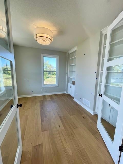 Front office with windows on two sides and custom built in cabinets.