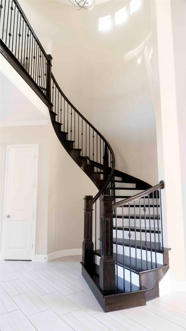 Elegant curved staircase with dark wood tones and