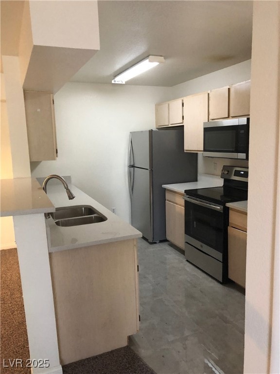 Kitchen with appliances with stainless steel finishes, light countertops, and a​​‌​​​​‌​​‌‌​​​‌​‌​​​‌‌​​​‌‌​​​​​​‌‌​‌‌‌ peninsula