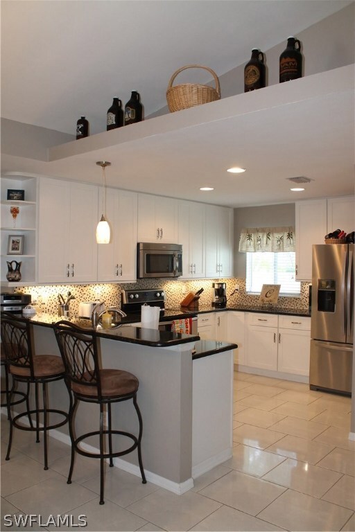 Kitchen features new cabinets, new granite counters, new stainless steel appliances and lighting.