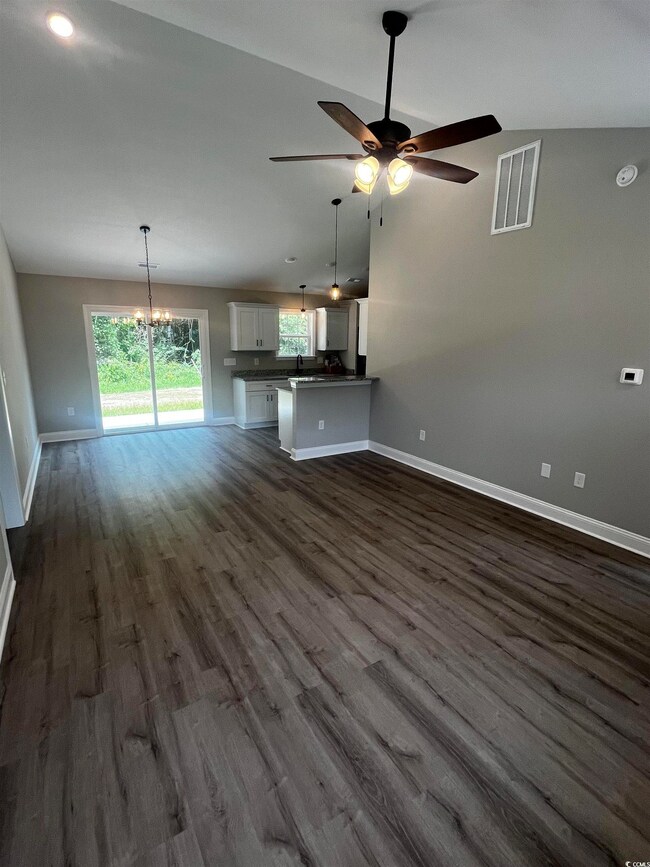 Unfurnished living room with dark wood-type floori
