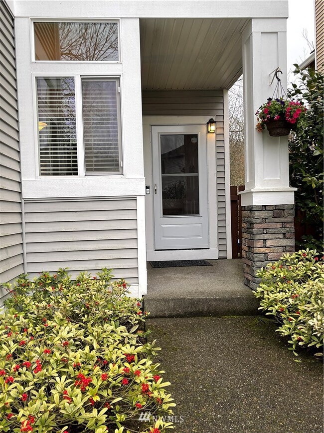 Just one step into the covered entry with screen door, 