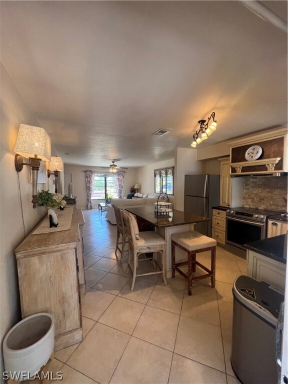 Dining room featuring ceiling fan and light tile floors