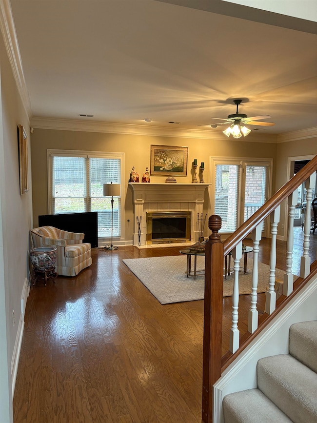Living room featuring a tile fireplace, hardwood /