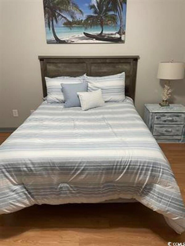 Bedroom with dark wood-type flooring