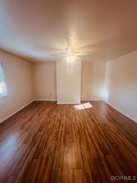 Unfurnished room with dark wood finished floors, a
