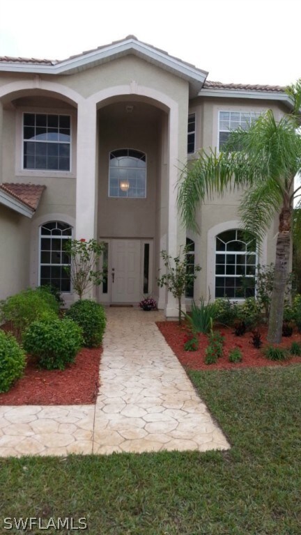 Grand entry lined with beautiful landscaping.