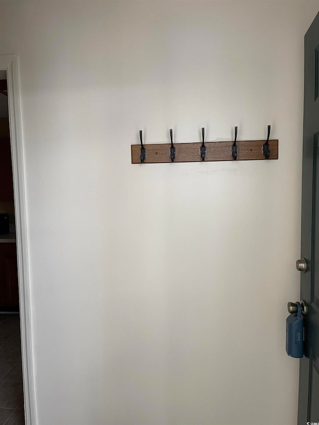 Mudroom with dark tile patterned floors