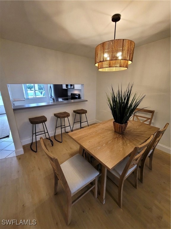 Dining room featuring an inviting chandelier, base