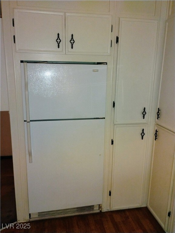 Detailed view of freestanding refrigerator and woo