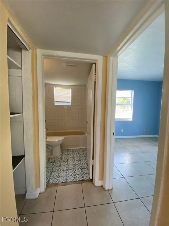 Bathroom featuring light tile patterned floors and plenty of natural light