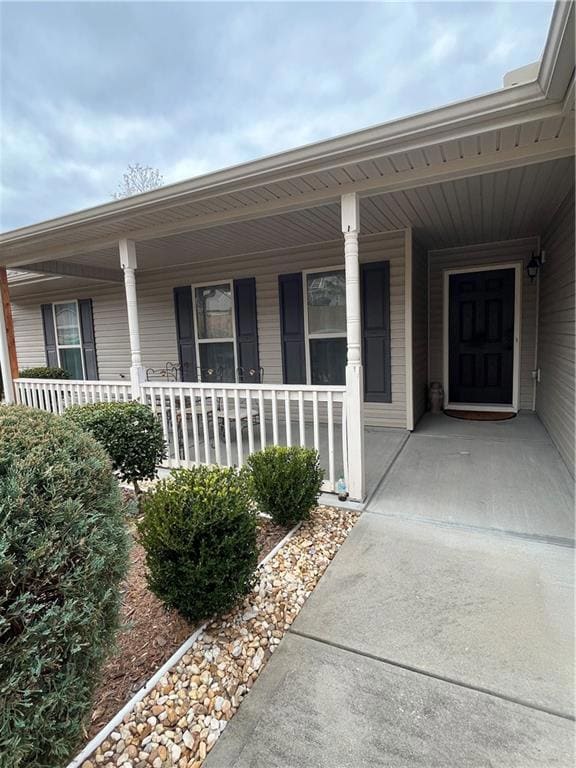 Doorway to property featuring a porch