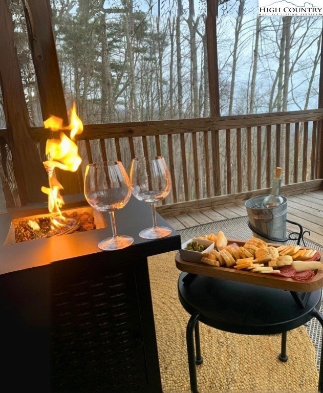 Enjoy a glass of wine by the fire on the screened in porch