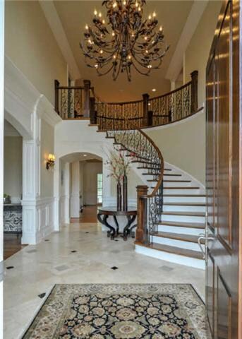 Enter into a marble  Foyer, accented with elaborate crown molding and a breathtaking staircase with extensive, iron spindles and hardwood treads on the stairs leading to the second floor.