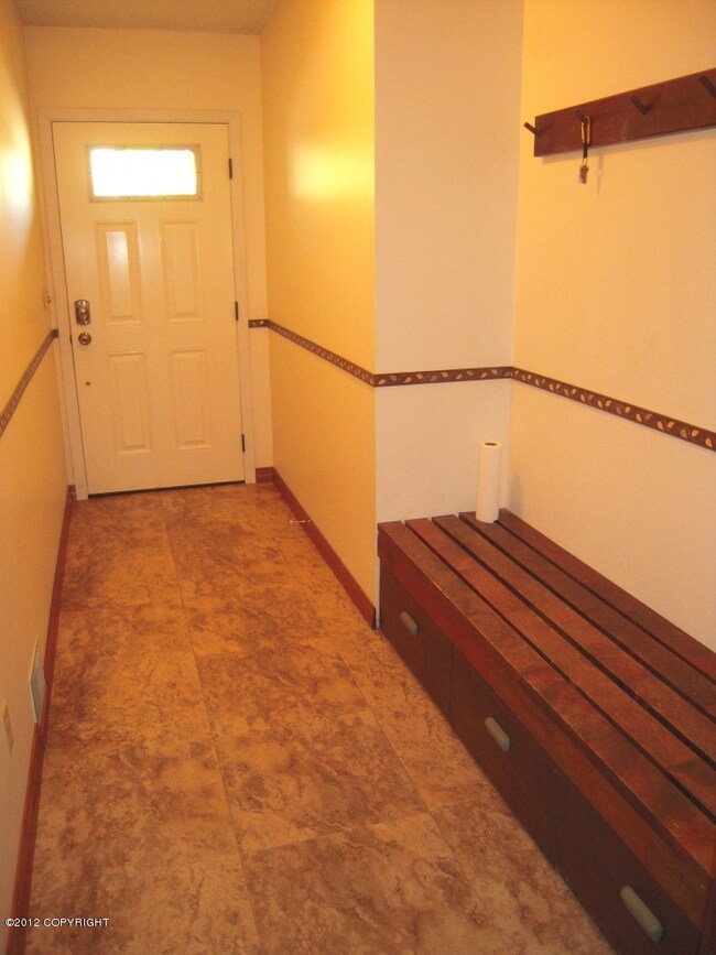 Spacious Entry has bench, hooks, closet