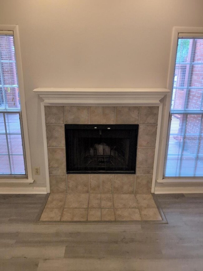 Detailed view of a tiled fireplace and wood finis