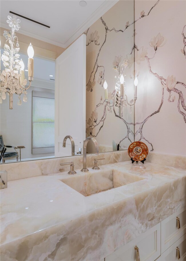 Bathroom featuring a chandelier, vanity, and ornam