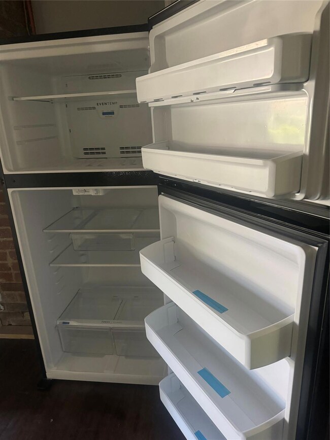 Interior details with dark hardwood / wood-style floors and white fridge