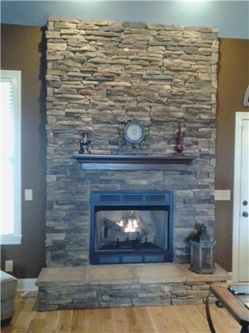 COZY STACKED STONE FIREPLACE WITH GAS LOGS....ENJOYING THE WARMTH OF THE FIRE WITH A CLICK OF A BUTTON!  AWESOME!