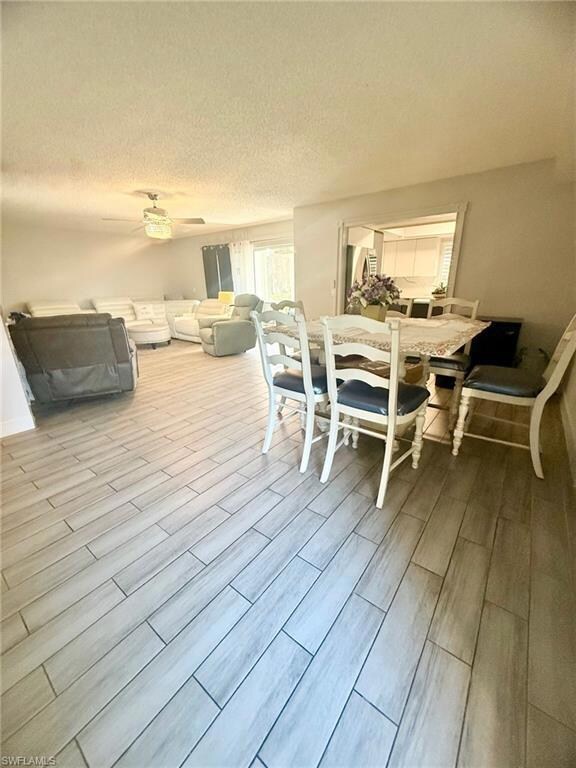 Dining room with a textured ceiling and wood tiled