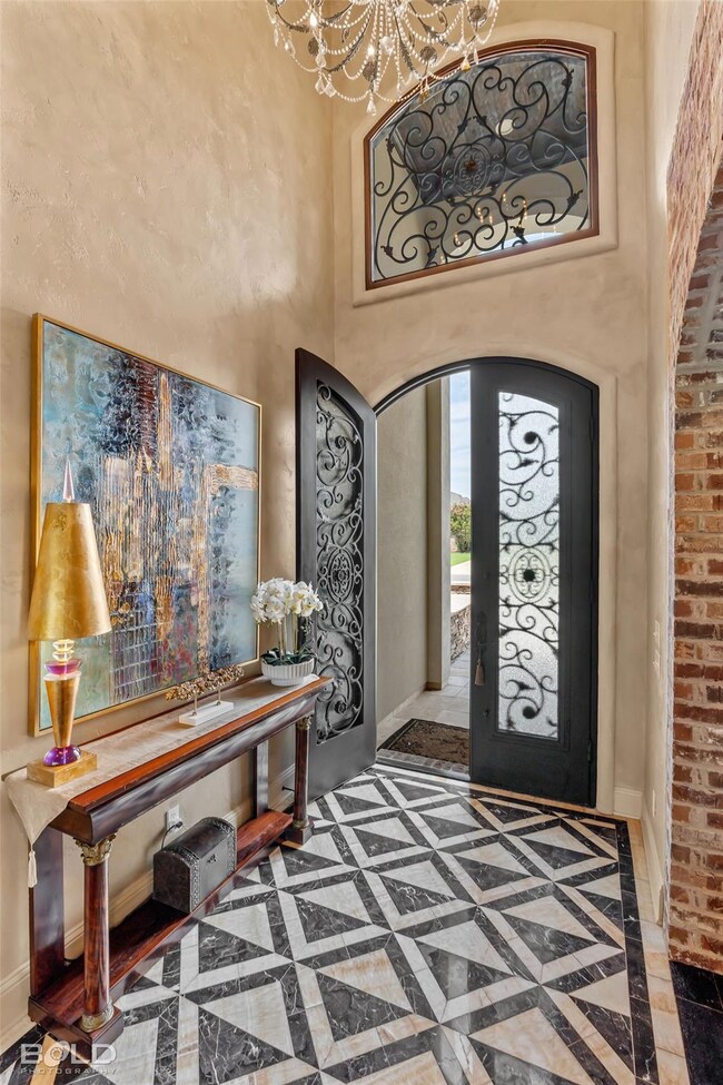 Marble flooring foyer featuring a towering ceiling
