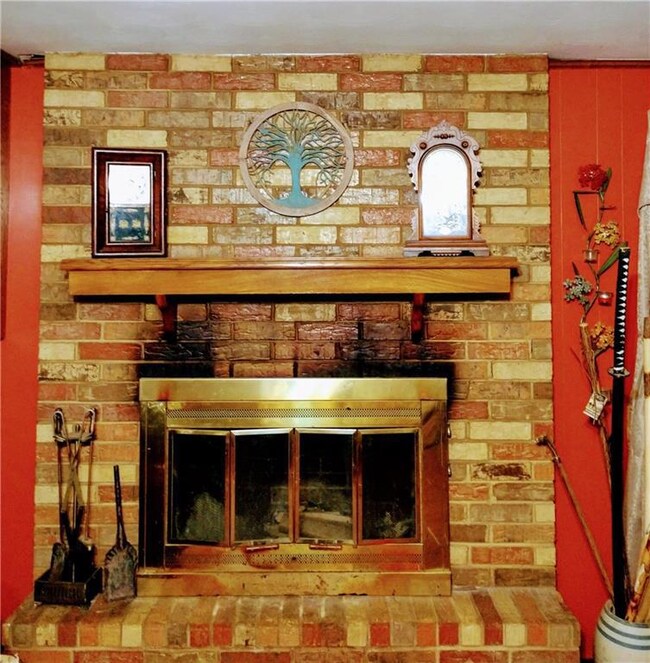Large Masonary wood burning fireplace provides war