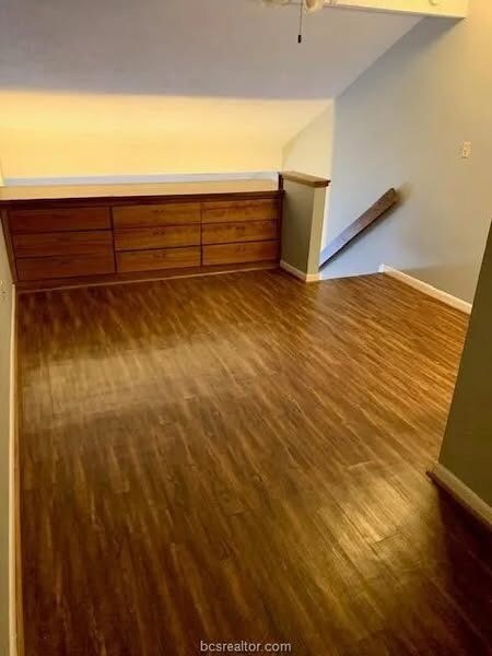 Unfurnished room with dark hardwood / wood-style f