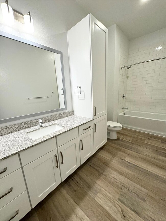 Full bathroom with hardwood / wood-style floors, v