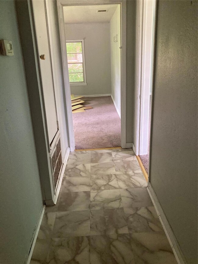 Hallway featuring carpet floors