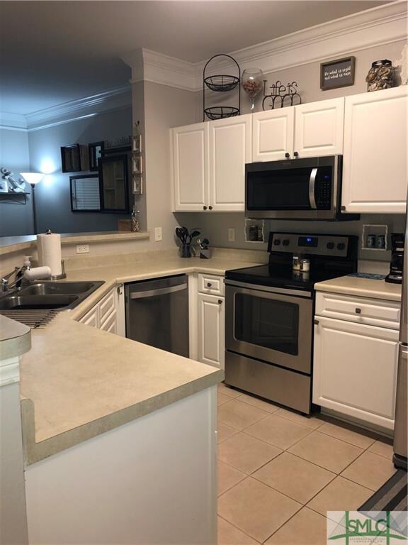 Open kitchen with new stainless steel appliances.