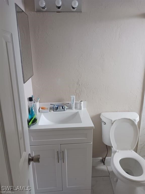Bathroom with tile patterned flooring, vanity, and