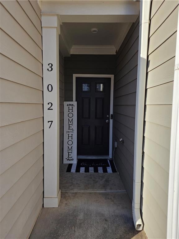 Entrance to property featuring covered porch