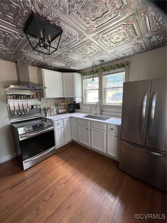 Kitchen with fridge, stove, wood finished floors,