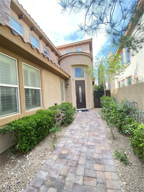 Property entrance featuring a tiled roof, stucco s