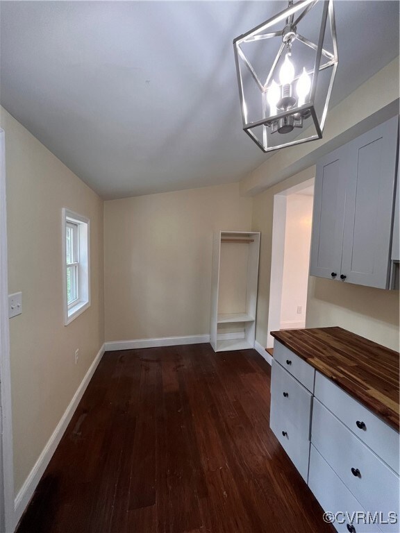 Inviting office or den  with chandelier and dark w