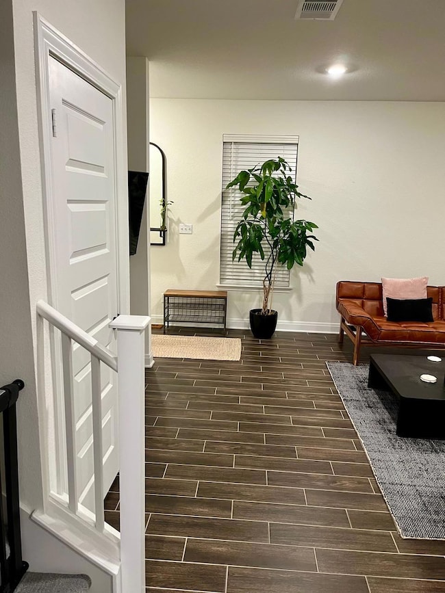 Hallway with wood finish floors and baseboards