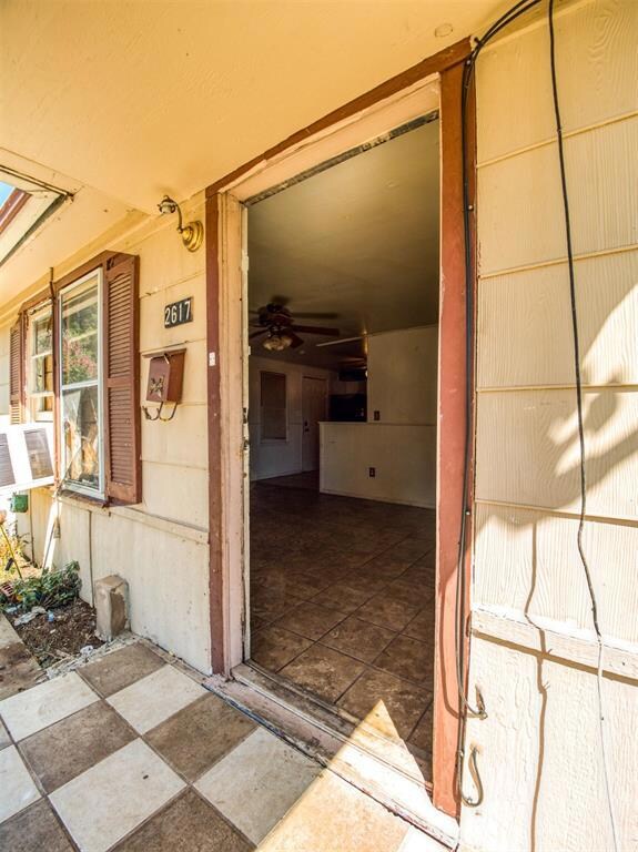 View of exterior entry with a patio area