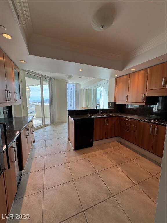 Kitchen featuring ornamental molding, a sink, dark
