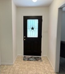 An open entryway with a Texas style front door.