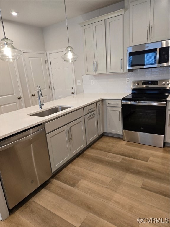 Kitchen with stove, light wood-style floors, dishw
