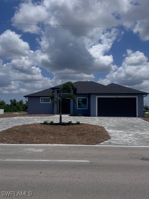 Prairie-style home featuring decorative driveway a
