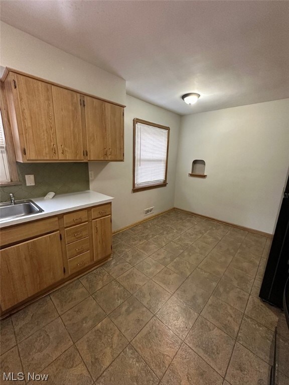 Kitchen with light tile floors and sink